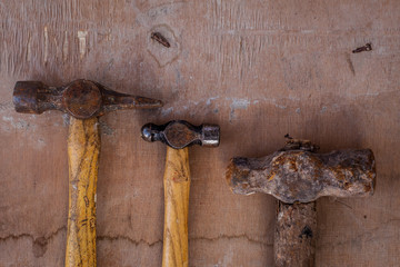 old vintage hammer on the old wood for the carpenter working, rusty carpenter tool