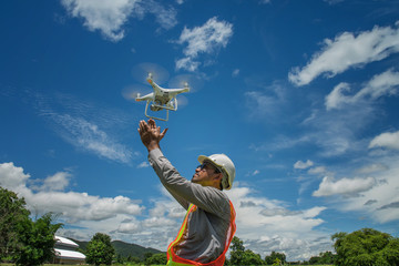 Young engineer use drones outdoor with beautiful sky with clouds
