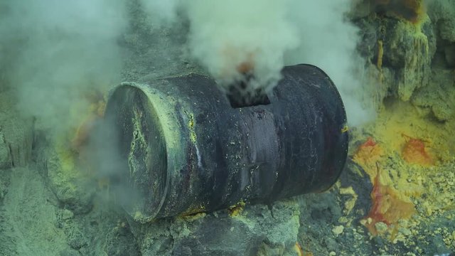Extraction of sulfur in the crater of a volcano. Sulfur gas, smoke. Kawah Ijen, crater with acidic crater lake where sulfur is mined. Ijen volcano complex is a group of stratovolcanoes in the