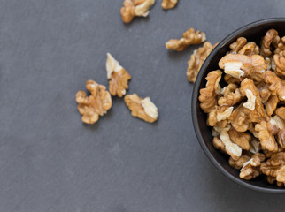 wallnuts in bowl on grey table