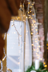 Naklejka na ściany i meble decor, comfort, celebrating concept. there is magic and romantic atmosphere because of twinkle lights hanged under the windowsill of original form of semicircle