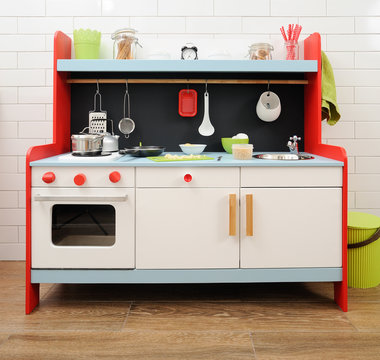 Stylish toy kitchen with utensils ready for making apple pie with children
