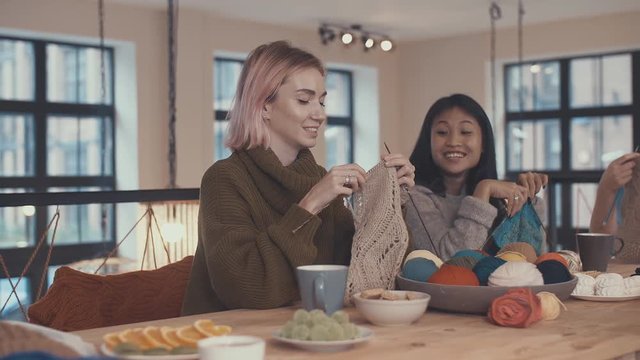 Young knitting women in studio