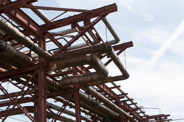 Fototapeta premium Close-up of pipelines and destillation tanks of an oil-refinery plant