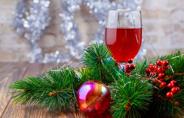 Red wine glasses and christmas balls on snow