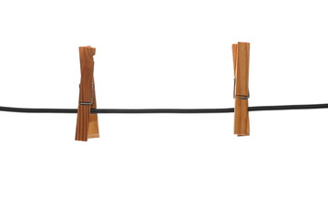 Old wooden clothespins on a rope isolated on white background