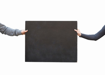 art, advertisment, pattern concept. on the white background there is small type of blackboard with negative space for text, it is held by two hands of people in warm grey sweatshits