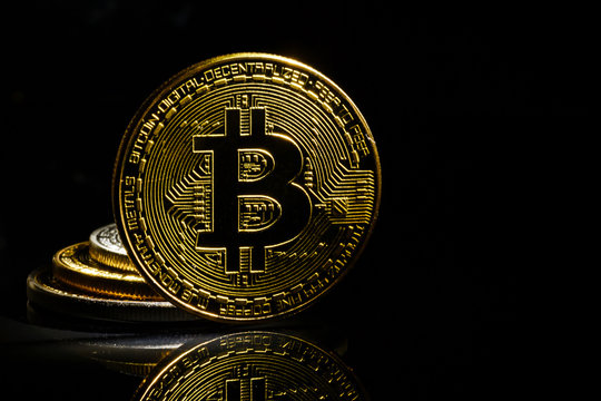 Golden bitcoin on black background with copy space cryptocurrency mining concept 