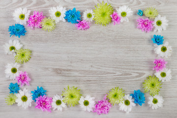 Garden flowers composition on white wooden table with copy space.