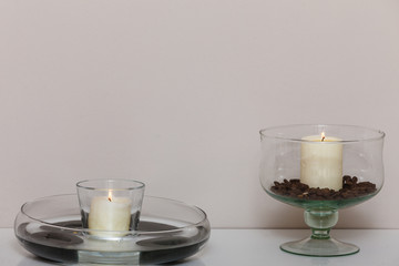 Decorative candles in bowls with coffee seeds