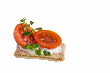Sandwich with tomato, cheese and rosemary on a white background.