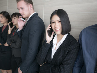 Asian woman using smartphone for work with team. People working concept.