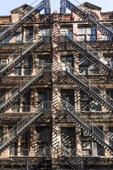 facade of old brick houses i NEw York with iron fire laders