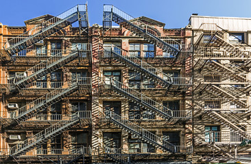 facade of old brick houses i NEw York with iron fire laders