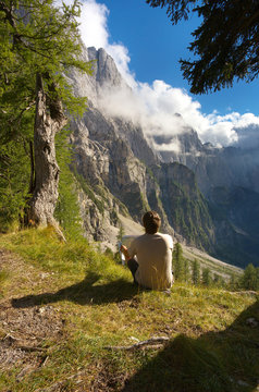 Resting man watching a mountain landscape, Triglav National Park, Slovenia