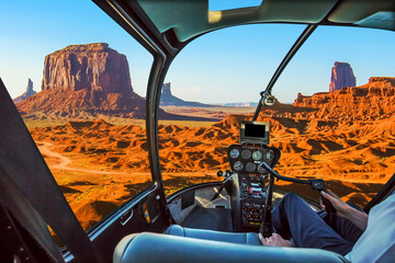 Helicopter cockpit with pilot arm and control console inside the cabin on scenic flight of Monument Valley Navajo Tribal Park, Arizona and Utah, America.