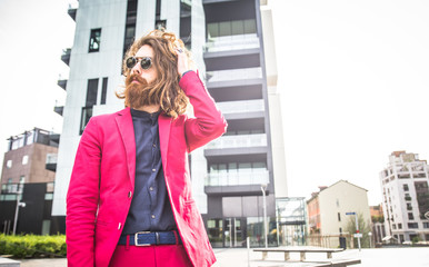 Long haired man in red suit and sunglasses