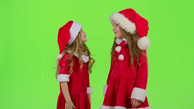 Baby of the assistant Santa Claus say quietly to their elves. Green screen