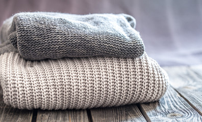 beautiful knitted clothes, neatly folded, close-up, handmade sweaters.