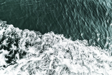Waves which are caused by ship on the sea, surface divided to areas, place for the text
