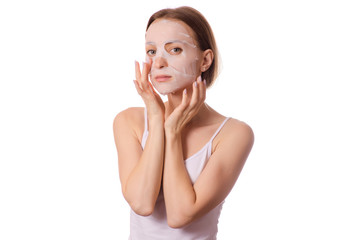 Beautiful young woman a tissue mask on her face beauty cosmetics