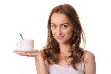 Beautiful young woman holding a white cup and saucer with coffee tea
