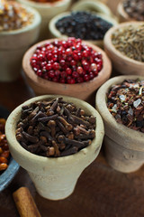 Variety of different asian and middle east spices, colorful assortment, on old wooden table