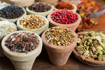 Variety of different asian and middle east spices, colorful assortment, on old wooden table