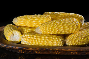 Raw sweet corn, yellow ripe corn ears