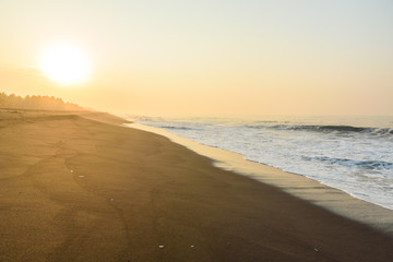 Fototapeta na wymiar Sunset at Beach with Black Sand in Monterrico, Pacific coast of Guatemala. 