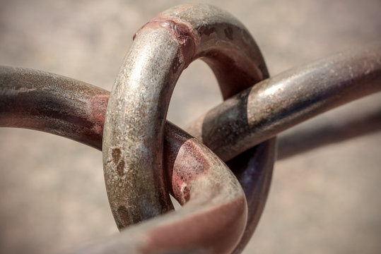 Links of a metal chain with rust spots