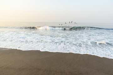 Sunset at Beach with Black Sand in Monterrico, Guatemala. Monterrico is situated on the Pacific coast. Known for its volcanic black sand beaches and annual influx of sea turtles. 