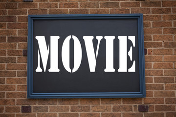Obraz premium Conceptual hand writing text caption inspiration showing announcement Movie. Business concept for Entertainment Movie Film written on frame old brick background with copy space