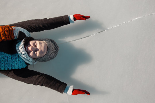 Woman Enjoying Beautiful Day On Frozen Lake