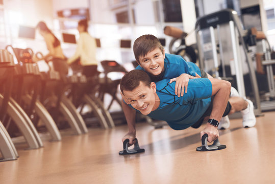 Dad and son in the same clothes in gym. Father and son lead a healthy lifestyle.