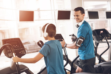 Dad and son in the same clothes in gym. Father and son lead a healthy lifestyle.