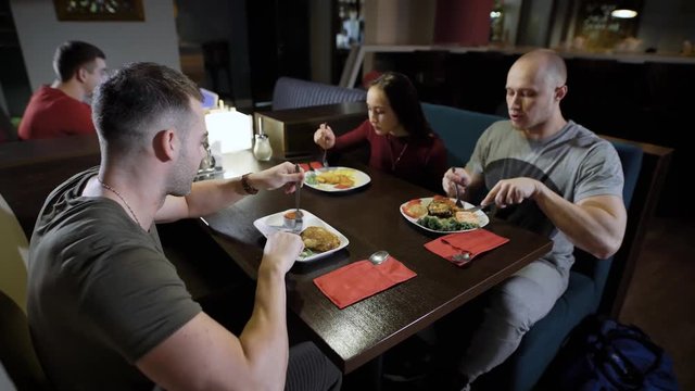 Three friends get together in cafe.