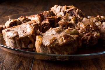 Lamb Meats in glass bowl on dark wooden surface.