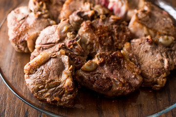 Lamb Meats in glass bowl on dark wooden surface.