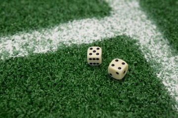 Two dices on artificial grass