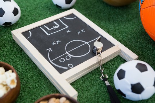 Strategy board, whistle and football on artificial grass - Powered by Adobe