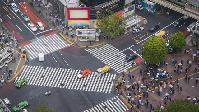 Pedestrian scramble crosswalk in Shibuya, Tokyo. High angle time lapse. Crossing is one of the busiest and crowded in the world