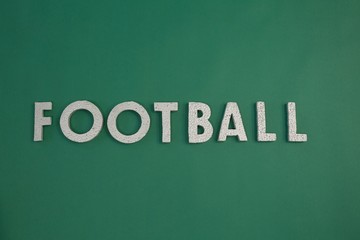 Word football arranged on green background