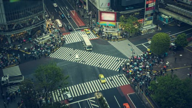 Pedestrian scramble crosswalk in Shibuya, Tokyo. High angle time lapse of people crossing the street in business district. Vintage tone