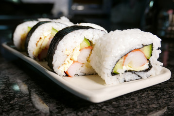 Sushi rolls on marble table