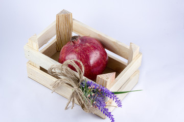 a small crate with pomegranate