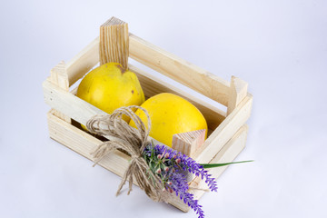 a small crate with quinces