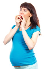 Happy woman in pregnant eating fresh apple, concept of healthy nutrition during pregnancy