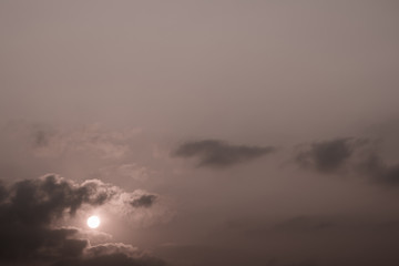 Gray fluffy clouds in the morning sky with sunlight