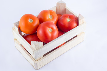 a small crate with tomatoes